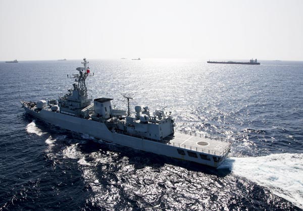The missile destroyer Yancheng, from the 16th Chinese naval escort flotilla, accompanies a group of commercial vessels through Somalian waters in the Gulf of Aden. HU QUANFU / FOR CHINA DAILY Navy lauded for foiling pirates