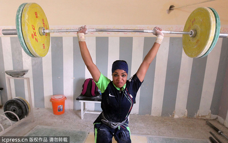 Fifteen-year-old Hoda lifts weights at a gym in Sadr City, on Sept 20, 2012. Public sports in post-war Iraq